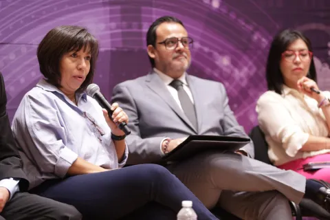 Personas ponentes del Foro Transparencia y Periodismo 2024 del INFO CDMX posan frente al fondo institucional.